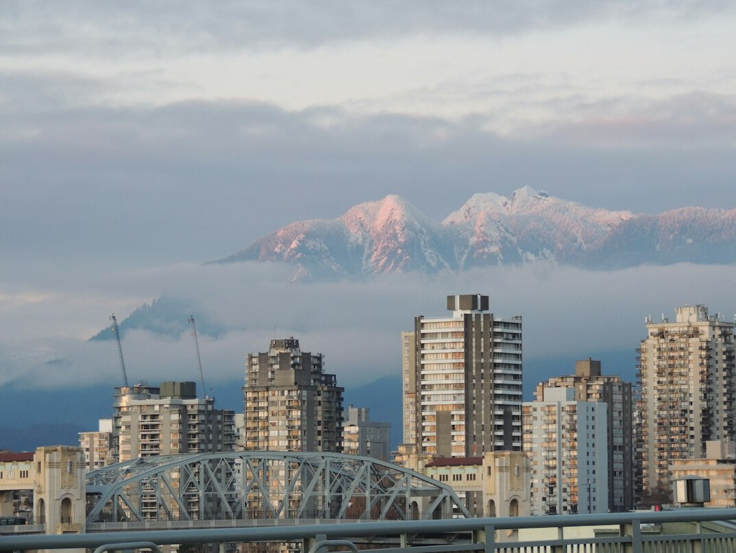 Vancouver city skyline with mountains at dusk