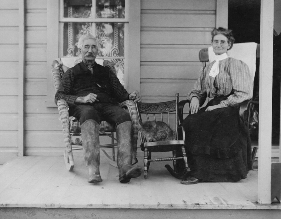 Journalist interviewing an elderly woman on her porch