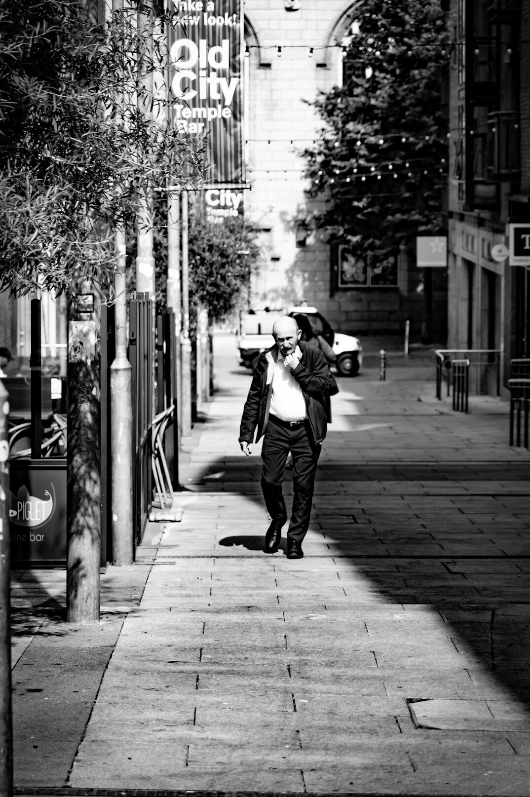 Documentary photographer holding a camera in a city alley